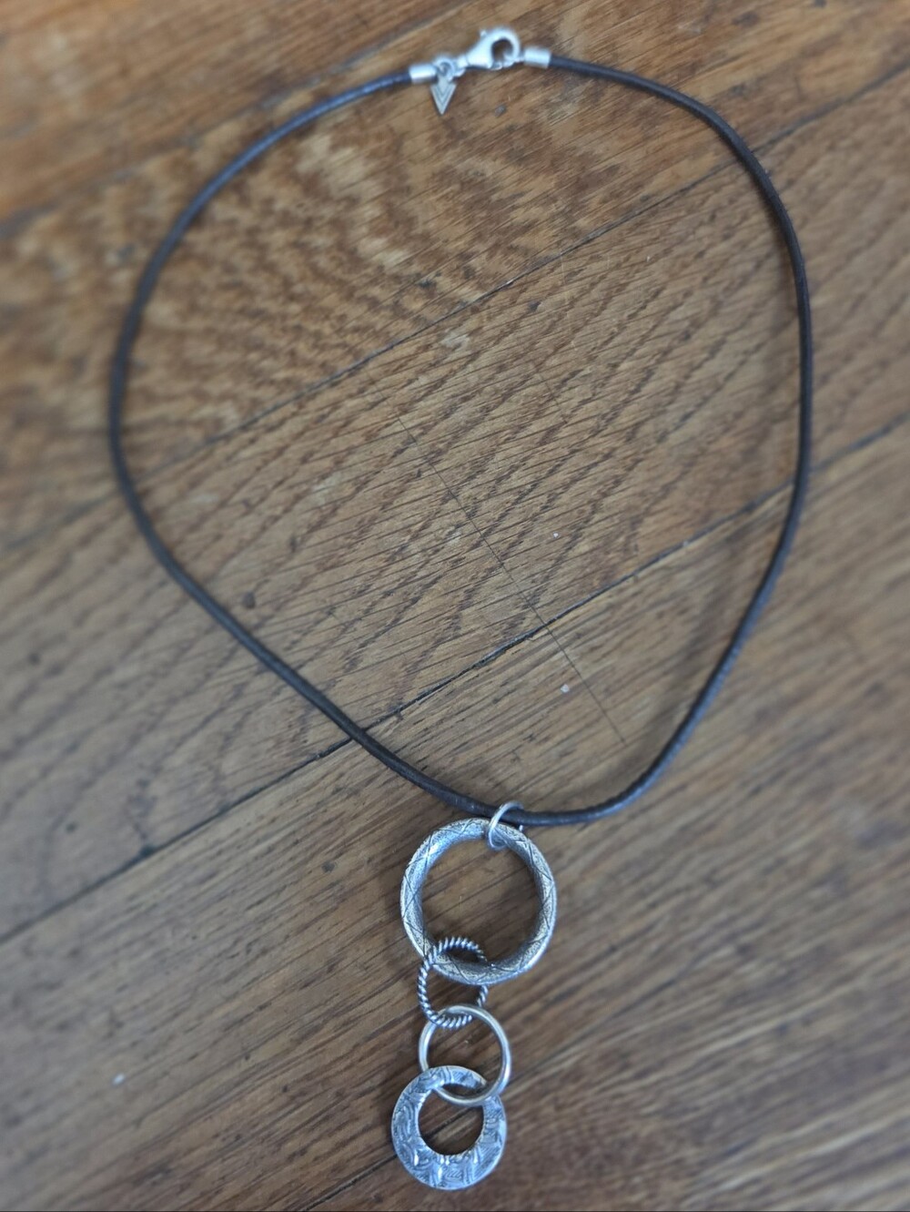 Silpada Sterling Silver Triple-Ring Pendant Necklace on Brown Leather Cord.